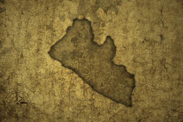 map of liberia on a old vintage crack paper background .