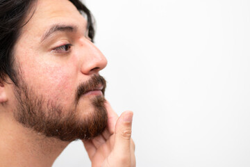Side view of face of man arabian with beard washing his face with water in white background and...