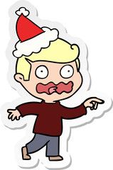 hand drawn sticker cartoon of a stressed out pointing wearing santa hat