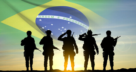 Silhouette of a soldiers against the sunset with Brazil flag. Armed Forces of Brazil concept. EPS10 vector