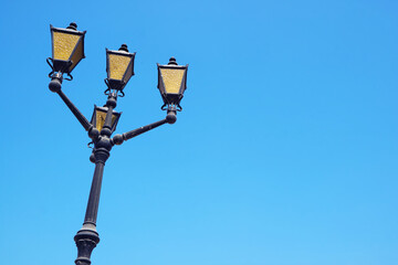 Fototapeta na wymiar Gorgeous Arabian Style Streetlamp Against Sunny Blue Clear Sky of Manama, Bahrain