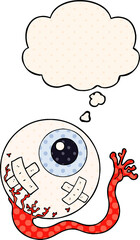 cartoon injured eyeball with thought bubble in comic book style