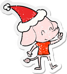 cute hand drawn distressed sticker cartoon of a elephant wearing santa hat