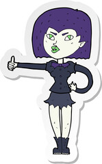 sticker of a cartoon vampire girl giving thumbs up