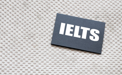 IELTS word on a black piece of paper.