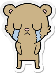 distressed sticker of a cartoon bear crying