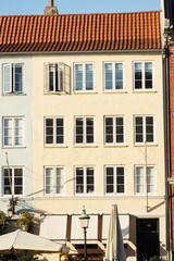 Fototapeta premium Yellow historic terraced house in Nyhavn in the center of Copenhagen in Denmark