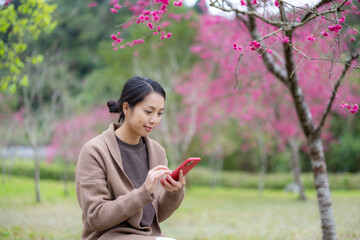 Woman use cellphone at park