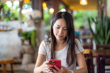 Woman use mobile phone in coffee shop