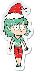 hand drawn distressed sticker cartoon of a elf girl staring wearing santa hat