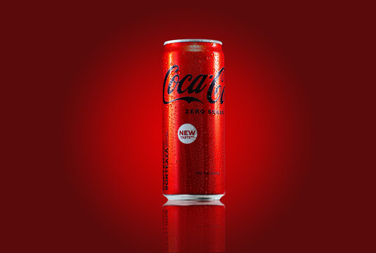 Zaporozhye, UKRAINE - MAY 28, 2023: Coca-Cola zero sugar can with water drops and reflection on red background.