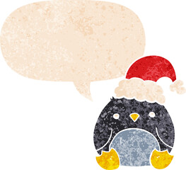 cute cartoon penguin wearing christmas hat with speech bubble in grunge distressed retro textured style