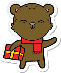 sticker of a happy cartoon bear with present