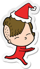 hand drawn sticker cartoon of a girl in onesie wearing santa hat