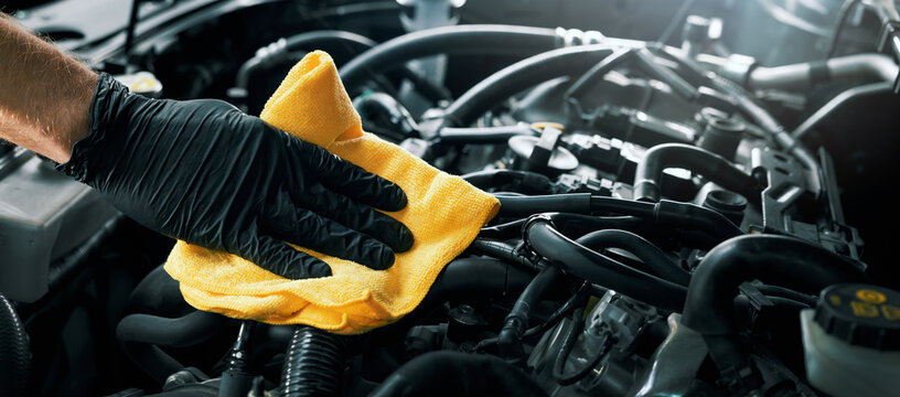 cleaning car engine with microfiber cloth. auto detailing. banner with copy space