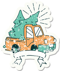 worn old sticker of a tattoo style truck carrying trees