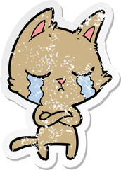 distressed sticker of a crying cartoon cat with folded arms