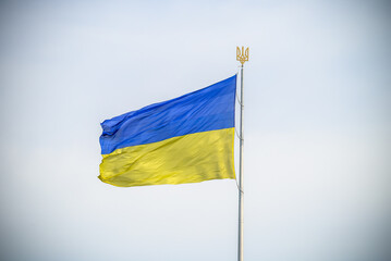 Ukraine flag large national symbol fluttering in blue sky. Large yellow blue Ukrainian state flag, Dnipro city, Independence Constitution Day, National holiday