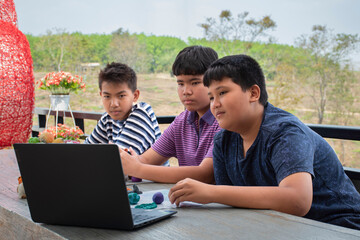 Obraz premium Autistic children molding plasticine prepared by their parents into different shapes and colors as they have learned from internet online on laptop for slower brain development than normal children.