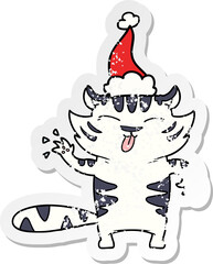 hand drawn distressed sticker cartoon of a white tiger wearing santa hat