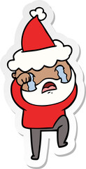 hand drawn sticker cartoon of a bearded man crying and stamping foot wearing santa hat