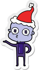 hand drawn sticker cartoon of a weird bald spaceman wearing santa hat