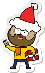 hand drawn sticker cartoon of a bearded man with present wearing santa hat