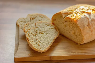 Printed kitchen splashbacks Bread close up fresh white sliced bread on wooden table in kitchen