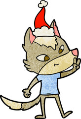 friendly hand drawn textured cartoon of a wolf giving peace sign wearing santa hat