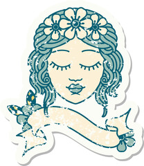 worn old sticker with banner of a maidens face