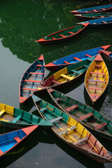 Boats floating on calm waters. Unconventional arrangement forms an intriguing, uncomposed...