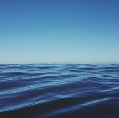 Fototapeta na wymiar Blue sea with waves, sky and skyline