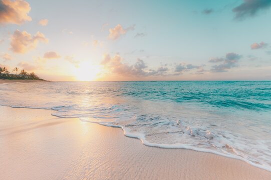 Sunrise on the seashore: the concept of relaxation, morning and success in life. Beautiful scenery of a beach resort