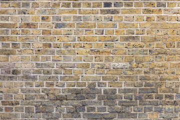Old weathered brick wall texture. Grunge urban street brick wall
