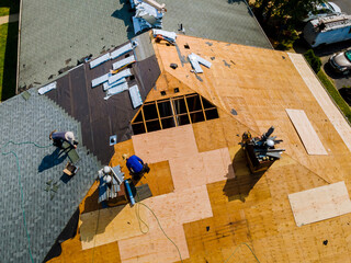 Apartment building roof underwent repairs that included installation of new shingles replacing old...