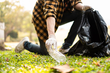 Closeup image of a hand picking up trash on World Environment Day,  showcasing our dedication to...