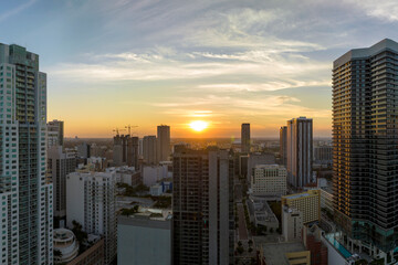 Obraz premium Aerial view of downtown office district of Miami Brickell in Florida, USA at sunset. High commercial and residential skyscraper buildings in modern american megapolis