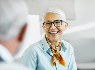 business businesswoman senior elderly office meeting woman portrait corporate manager smiling talking conversation happiness mature glasses communication discussion executive