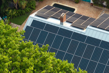 New residential house in USA with roof covered with solar panels for producing of clean ecological...
