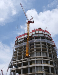 Tower cranes constructing a new residential build. Industrial construction.