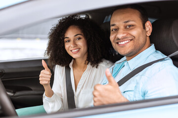 Smiling Arabic Couple Gesturing Thumbs Up Sitting In Auto