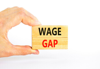 Wage gap symbol. Concept words Wage gap on wooden blocks on a beautiful white table white background. Businessman hand. Business, support and wage gap concept. Copy space.