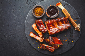 Barbecue pork spare ribs with hot honey chili marinade on black background