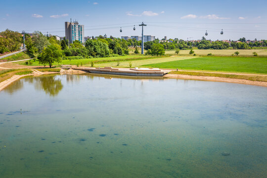 Pond in Mannheim city with ropeway connecting parks during federal horticulture and garden shows (Bundesgartenschau BUGA), Germany