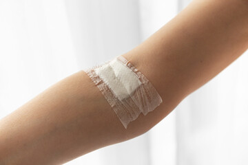 The site of the blood test from a vein on the arm is sealed with a plaster. Photo