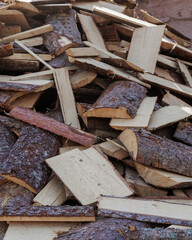 wooden firewood for fireplace and heating of country house. harvesting of wood for cold winter season. no people photo of textured wood chips, closeup. garden farm
