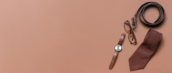 Stylish male accessories on brown background with space for text