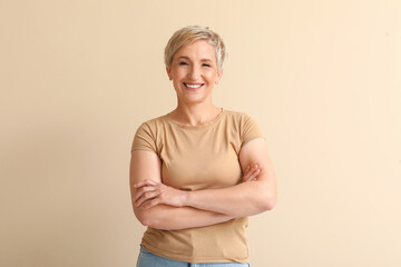 Mature blonde woman on beige background