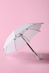 Mini umbrella on pink background