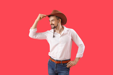 Handsome cowboy on red background